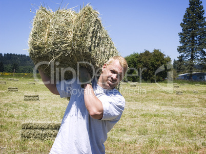 Man lifting hay bale