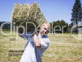 Man lifting hay bale