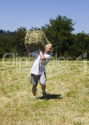 Man lifting hay bale