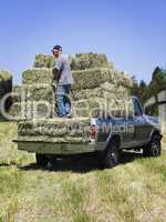 Man loading hay on truck
