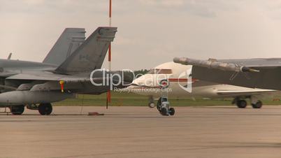 Challenger taxi past F18s