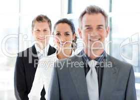 Smiling businesswoman in focus with her team
