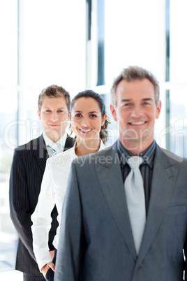 Young businesswoman in focus with her team