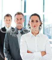 Businesswoman with folded arms in a line