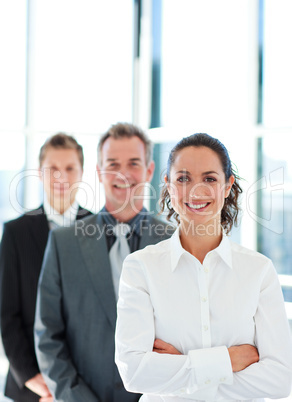 Smiling businesswoman with folded arms in a line