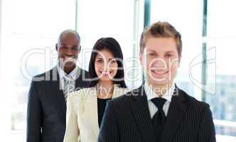 Smiling businesswoman in focus with her team