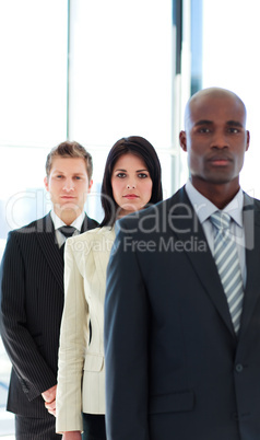 Serious businesswoman in focus with her team