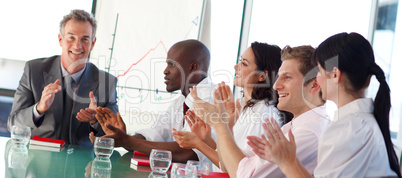 Business people clapping in a meeting