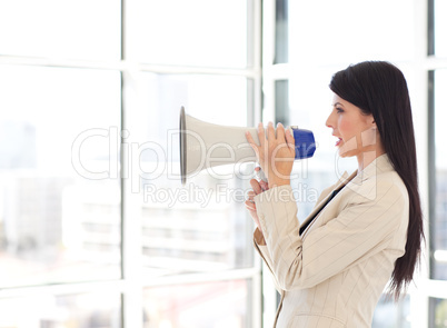 Businesswoman shouting in a megaphone