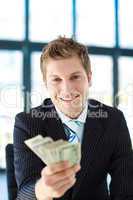Junior businessman holding dollars