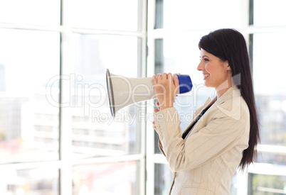 Businesswoman shouting through megaphone