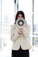 businesswoman shouting through megaphone