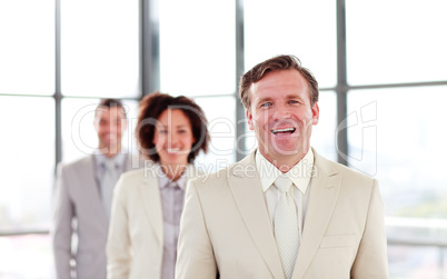 Smiling mature businessman leading a team