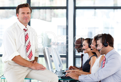 Confident senior manager in a call center