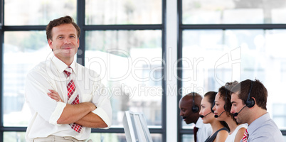manager with folded arms in a call center