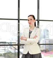 Serious businesswoman standing in an office