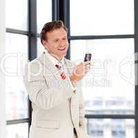 Portrait of a businessman sending a text