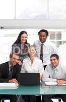 Smiling businessteam working together with a laptop