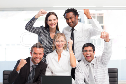 Happy business team celebrating a success in office