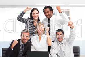Happy business team celebrating a success in office