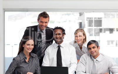 Business team working in an office looking at the camera