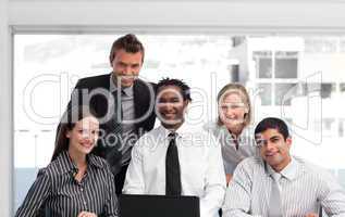 Business team working in an office looking at the camera