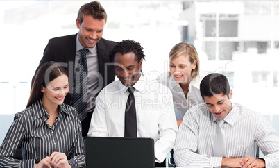 Multi-ethnic business team working with a laptop