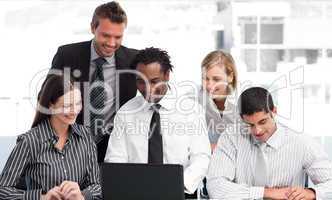 Multi-ethnic business team working with a laptop