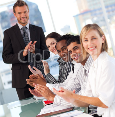 International business team clapping at the end of a presentatio