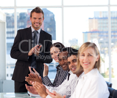 Businessman applauding with his team in a meeting