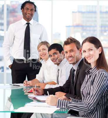 Happy business leader with his team in a meeting