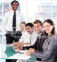 Happy business leader with his team in a meeting
