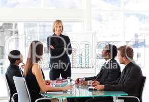 Businesswoman smiling with folded arms in a meeting