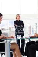 Businesswoman smiling at her team in a presentation