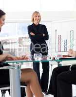 Attractive businesswoman smiling at her colleagues in a meeting