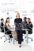 Business team smiling at the camera in a meeting