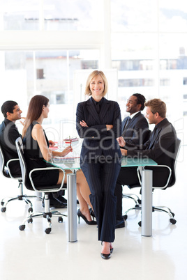 Friendly businesswoman smiling at the camera in a meeting