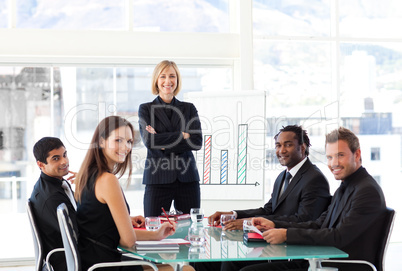 Businesswoman smiling at the camera in a meeting