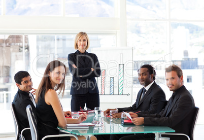 Serious businesswoman looking at the camera with her team