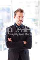 Attractive confident businessman with folded arms