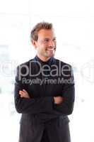 Smiling young businessman with folded arms