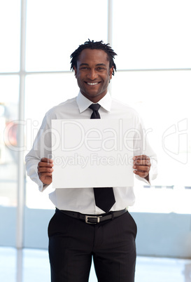 Smiling Afro-American businessman holding a white card