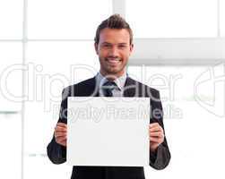 Smiling businessman holding a white card