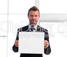 Serious businessman holding a white card