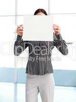 Businesswoman showing a white card in front of her face