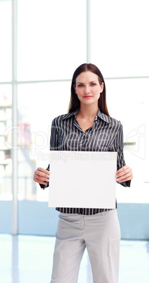 Serious woman showing a big business card