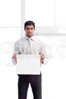 Serious businessman showing a white card