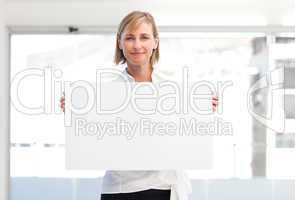 Mature woman showing a big business card