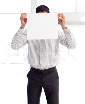 Businessman showing a white card covering his face