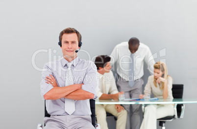 Businessman with a headset on looking at the camera